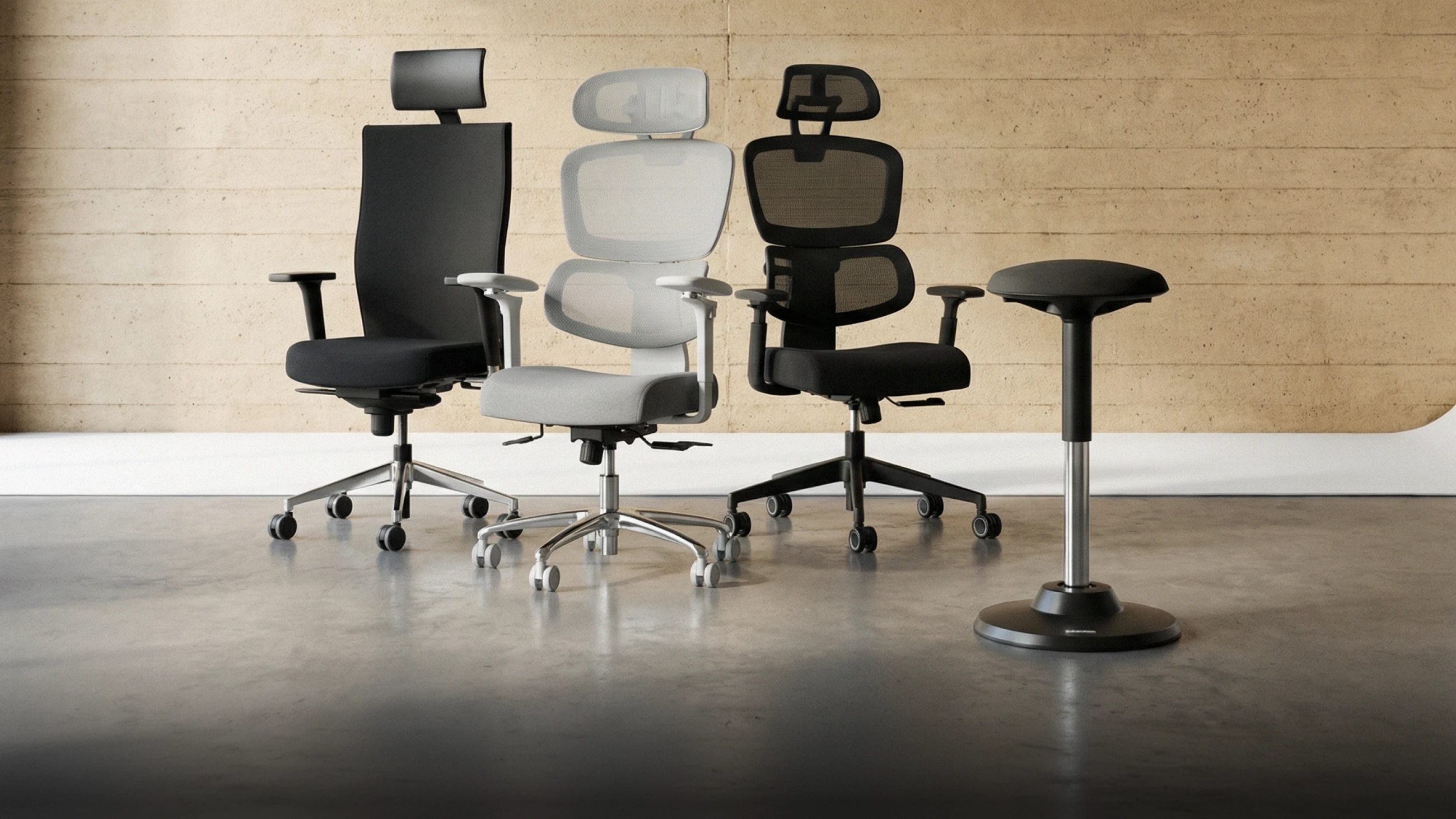 Three Deskspace office chairs and an active stool on a concrete floor