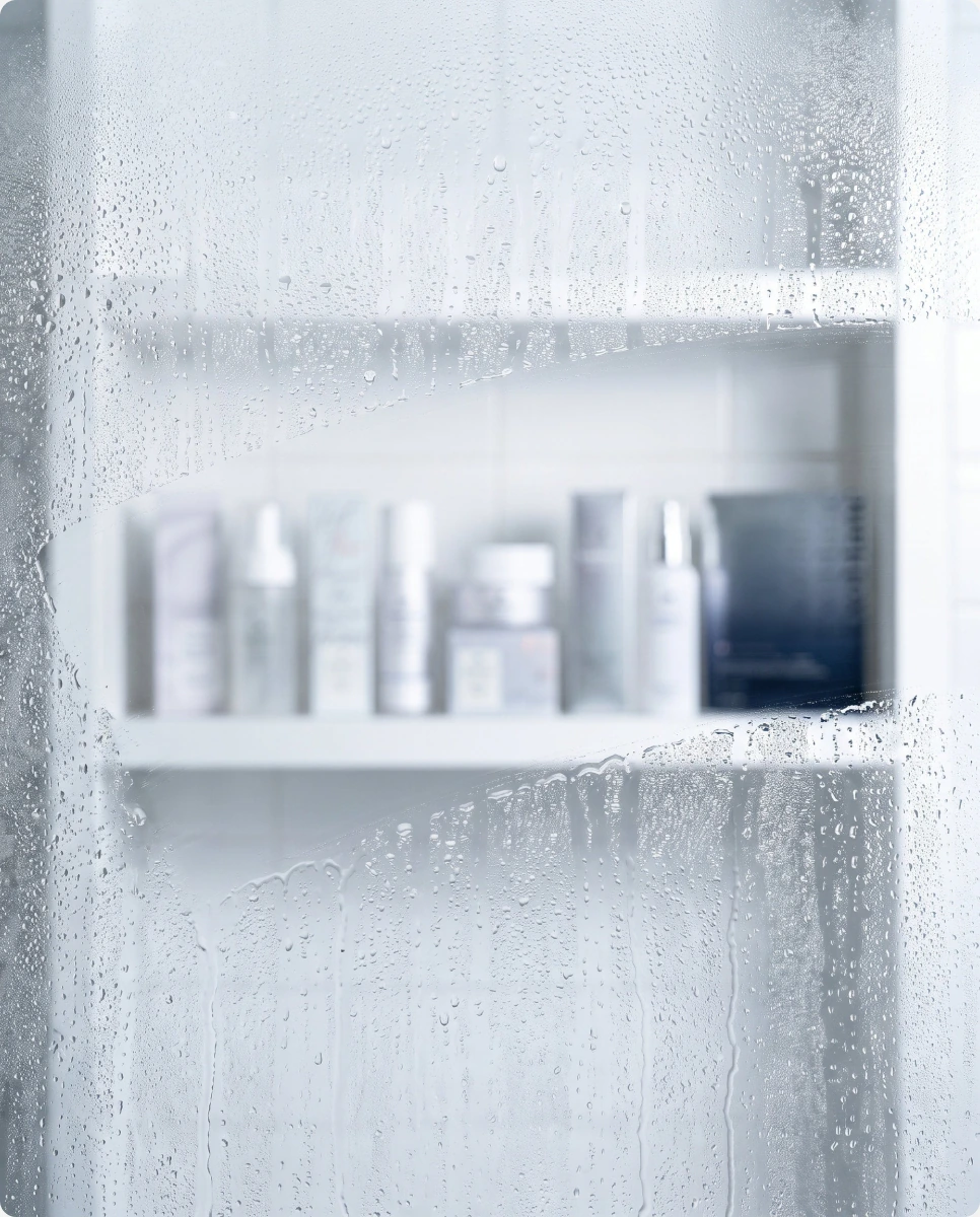 Variety pack products on a bathroom shelf behind a misted mirror